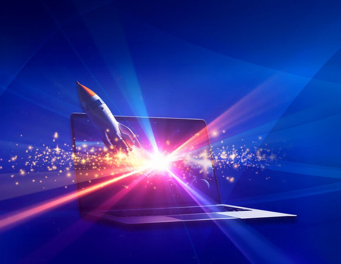 A laptop with a rocket launching from the screen